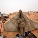FILE - In this Saturday, Feb. 21, 2015 photo, a Libyan soldier wakes his comrade in Al Ajaylat, 120 kilometers (75 miles) west of Tripoli, Libya. The work of photographer and video journalist Mohamed Ben Khalifa, who was killed in Libya on Saturday, Jan. 19, 2019, reflected Libya's post-2011 chaos of rival militias fighting for control as well as the humanitarian tragedy of waves of people fleeing North Africa, the Middle East and sub-Saharan Africa.